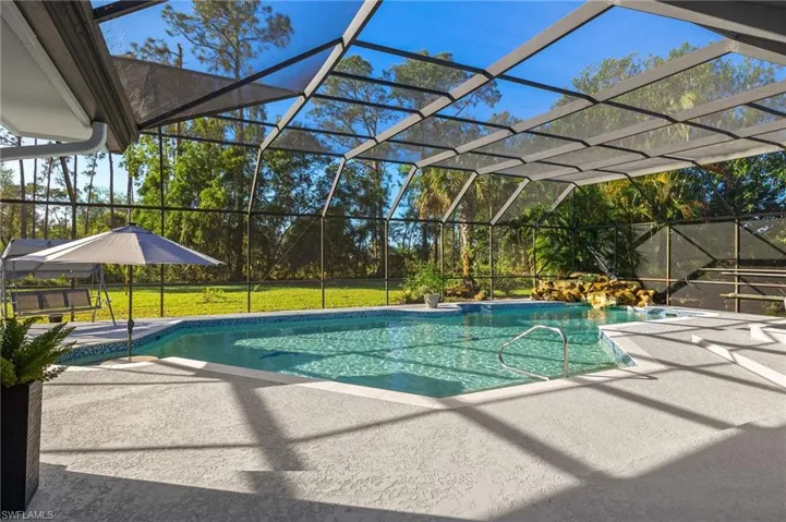 View of swimming pool featuring a patio and a lanai