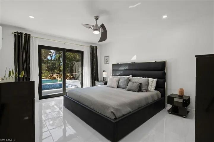 Owner's suite Bedroom featuring access to outside and ceiling fan