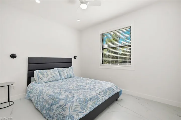 Guest House Bedroom 1featuring ceiling fan
