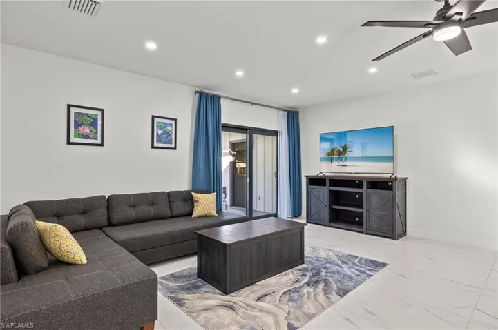 Guest House Living room featuring ceiling fan
