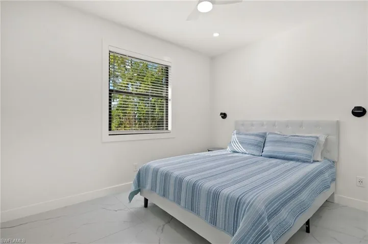 Guest House Bedroom 2 featuring ceiling fan