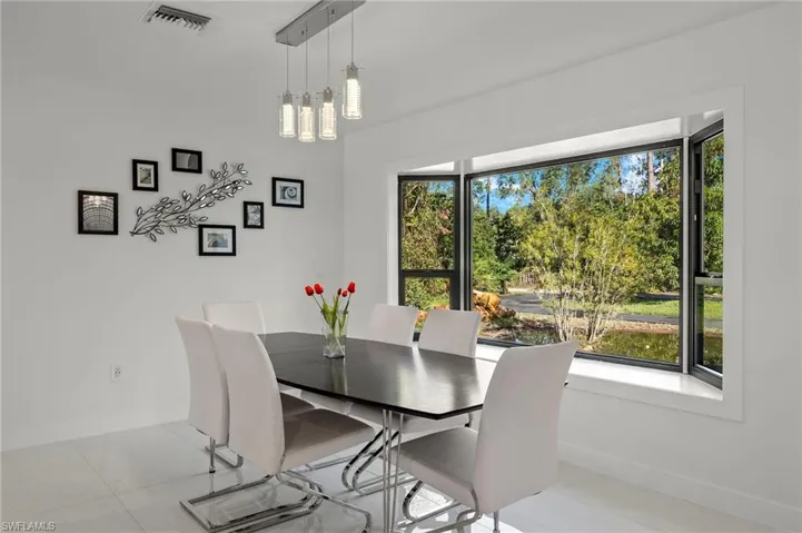 Dining room featuring light tile patterned floors and a notable chandelier