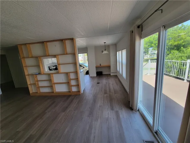 Unfurnished living room with wood finished floors