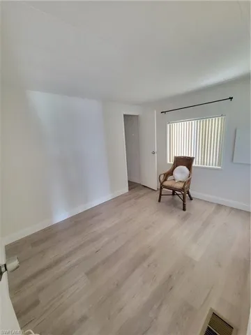 Spare room with light wood-style floors and baseboards