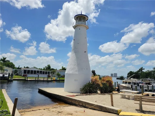 View of property's community with a water view and a boat dock