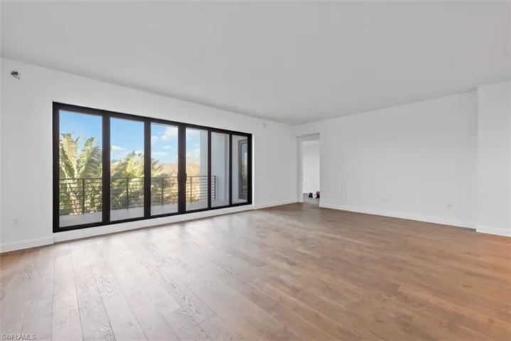Empty room with light wood-style floors and baseboards