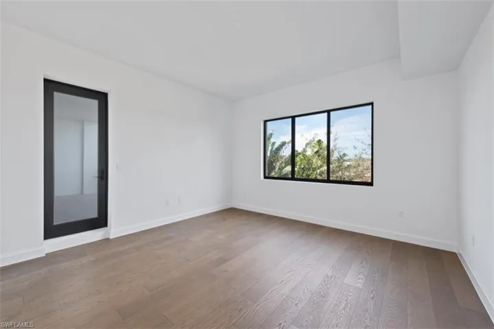 Spare room featuring baseboards and light wood-style flooring
