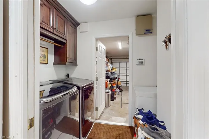 Laundry Room featuring cabinets,  washer and dryer, and laundry sink.