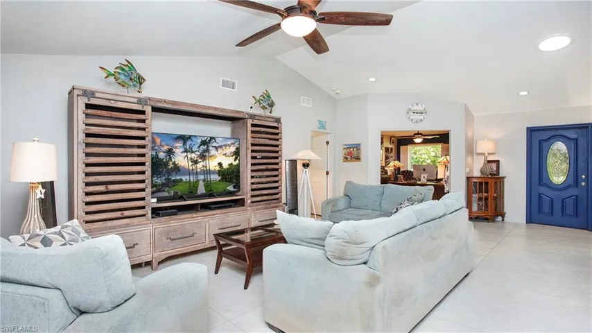 Living room with a ceiling fan, vaulted ceiling, and recessed lighting