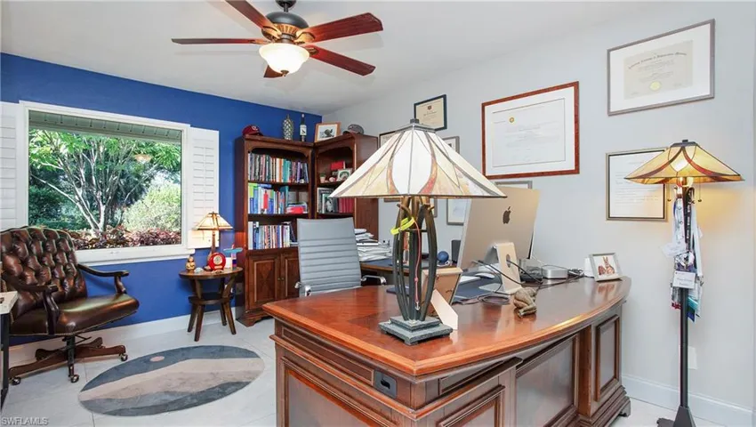Office featuring a ceiling fan and baseboards