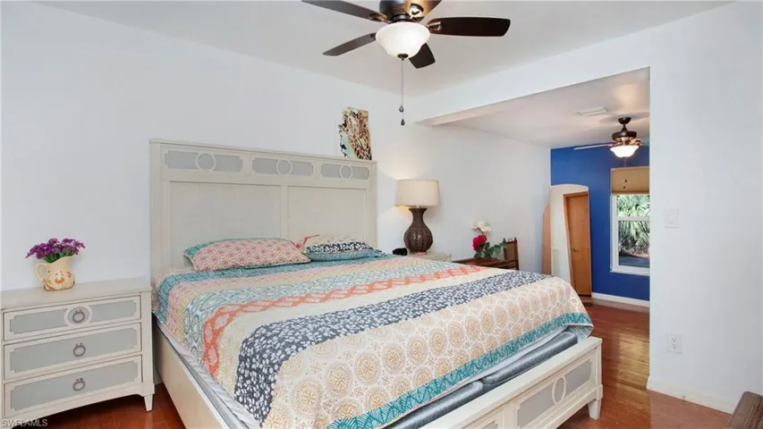 Bedroom with dark wood-style floors and a ceiling fan