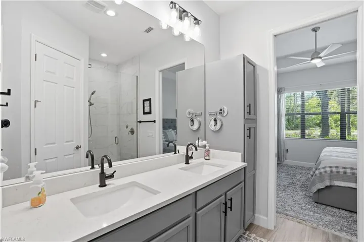 Primary ensuite bath with dual sinks and plenty of counter space.