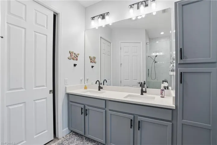 Walk in shower, beautiful cabinetry and a huge walk in closet.