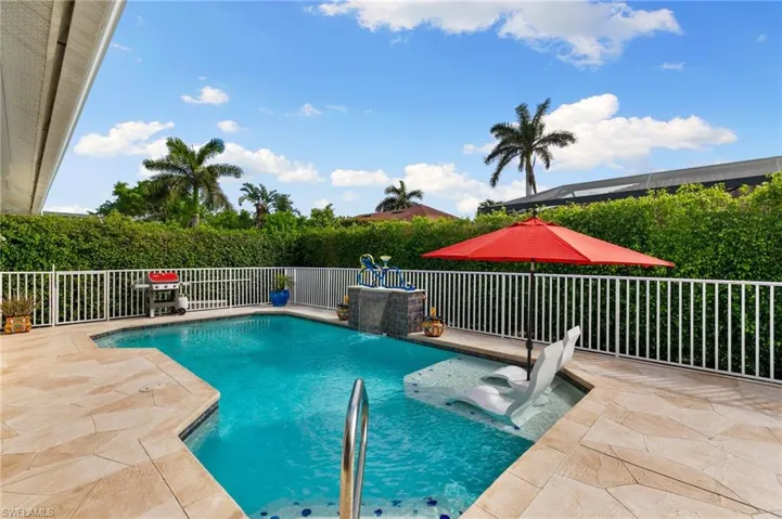 View of swimming pool with pool water feature and a patio