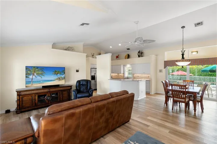 Living room with ceiling fan, crown molding.