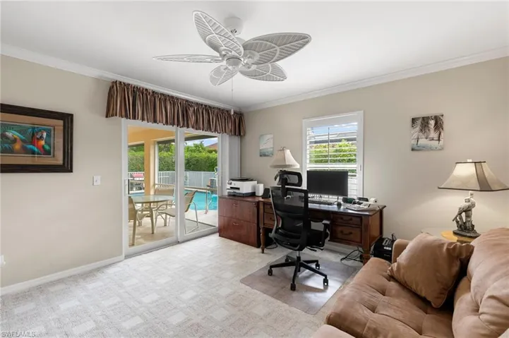 Third bedroom/Office featuring ceiling fan, crown molding, and light carpet
