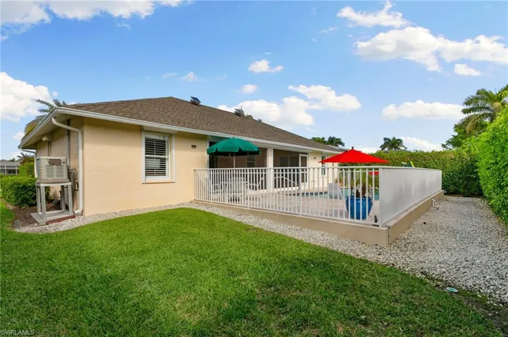 Back of house with a patio and a lawn