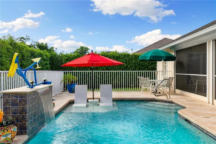 View of swimming pool with pool water feature and a patio