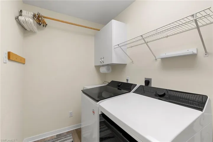 Laundry room with cabinets, washer and dryer