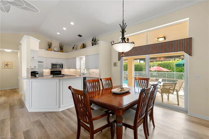 Dining room with ornamental molding, and vaulted ceiling