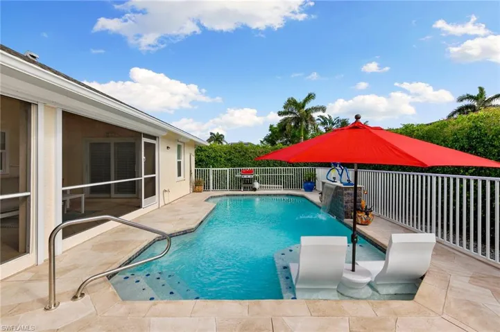 View of pool featuring pool water feature and a patio
