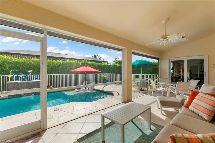 View of swimming pool featuring a patio and ceiling fan