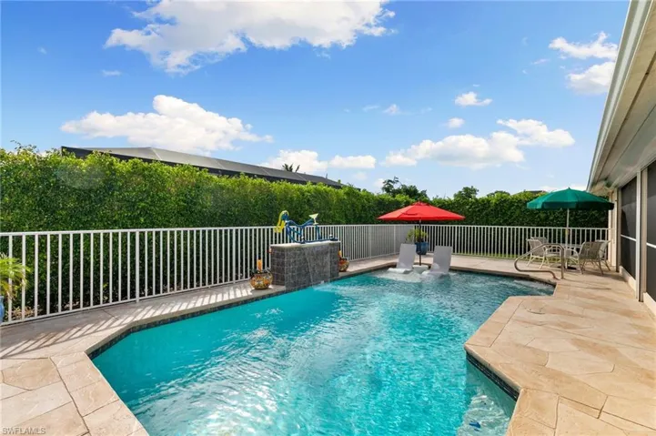 View of pool with pool water feature and a patio