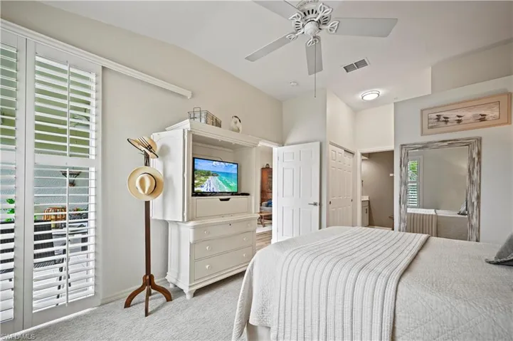 Bedroom featuring carpet floors, ceiling fan, vaulted ceiling, and a closet