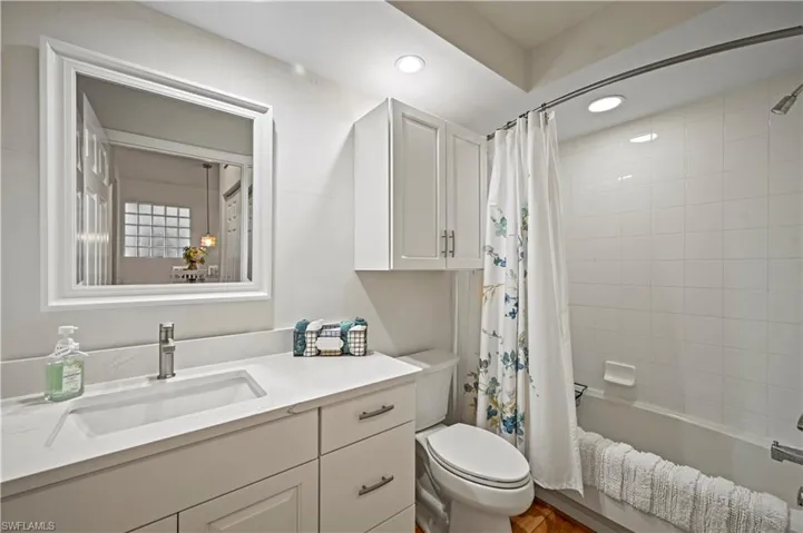 Full bathroom featuring shower / bath combo, toilet, and vanity
