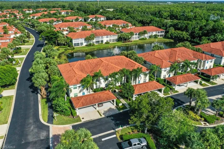 Birds eye view of property with a water view