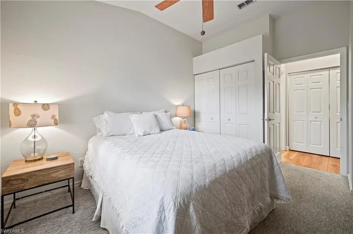 Bedroom featuring ceiling fan, vaulted ceiling, and light hardwood / wood-style flooring