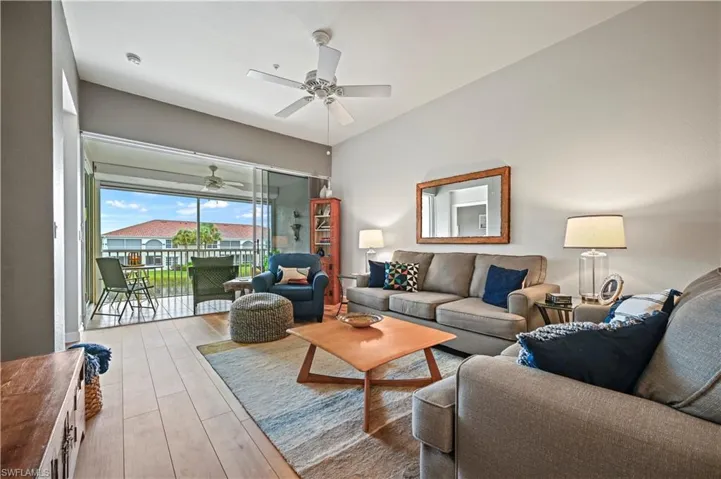 Living room featuring ceiling fan and light wood-type flooring