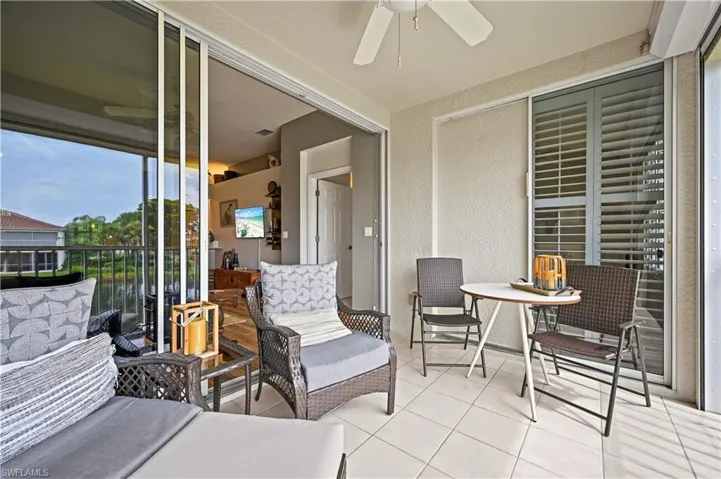 View of patio with a balcony and ceiling fan