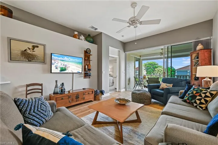 Living room featuring light wood-type flooring and ceiling fan