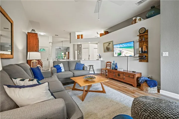 Living room featuring ceiling fan and light wood-type flooring