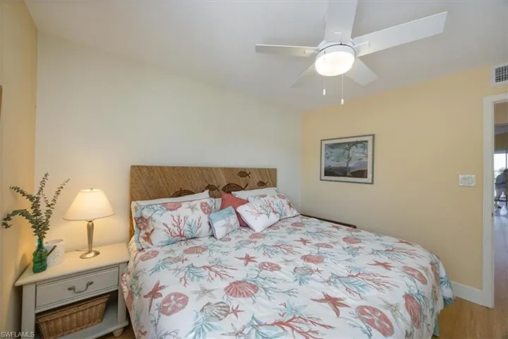Bedroom with ceiling fan and wood finished floors