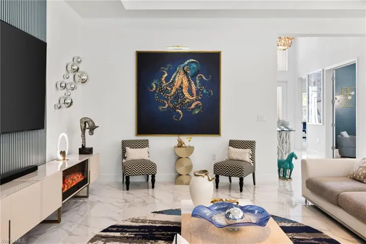 Living room featuring light marble finish floors and baseboards