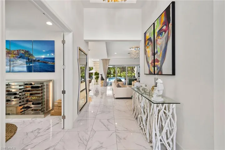 Hallway with hanging lights and light marble finish flooring