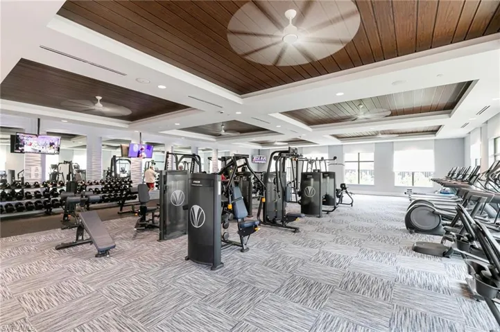 Workout area with wood ceiling, a ceiling fan, recessed lighting, and coffered ceiling