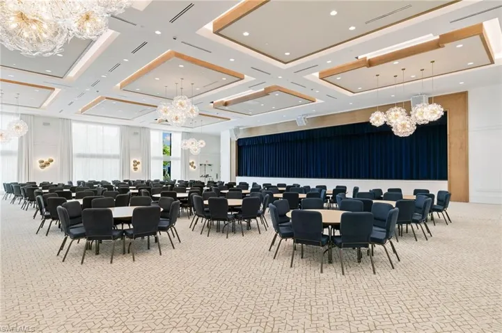 Dining area featuring a chandelier, light carpet, and high coffered ceiling