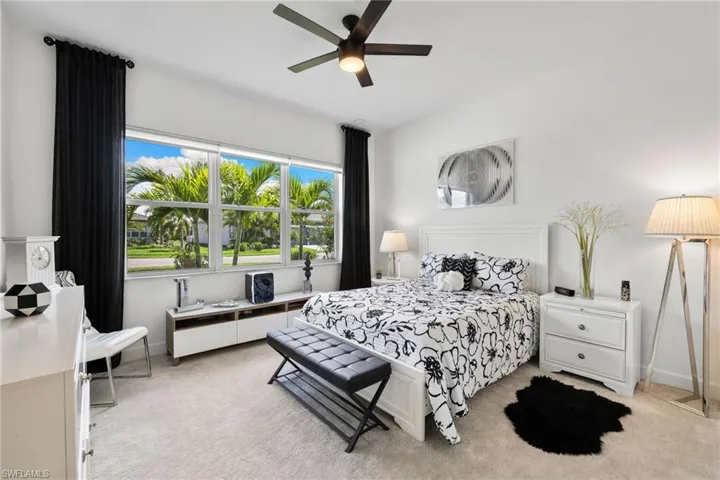 Guest Bedroom2 featuring light colored carpet and ceiling fan