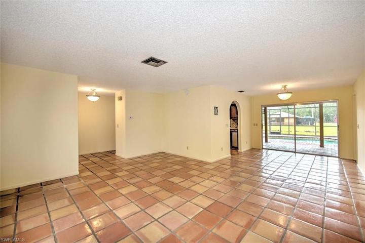 Living room looking out to back patio & pool