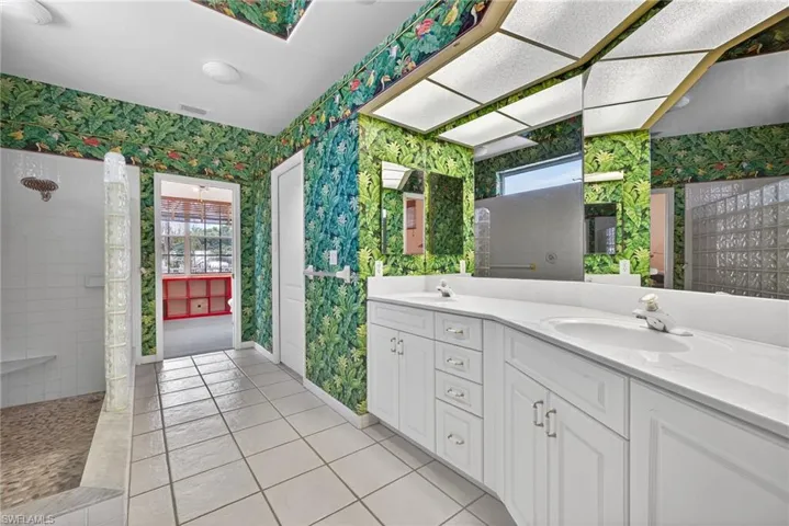Bathroom with double vanity and large walk in shower. Spacious walk in closet is accessed from the primary bathroom.
