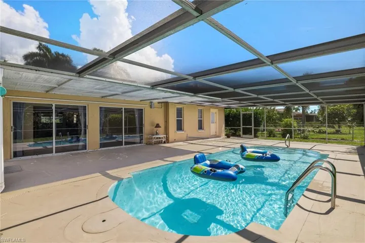 View of pool featuring a patio and a lanai