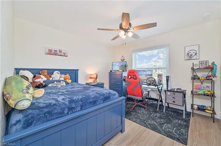 Bedroom featuring wood finished floors and a ceiling fan