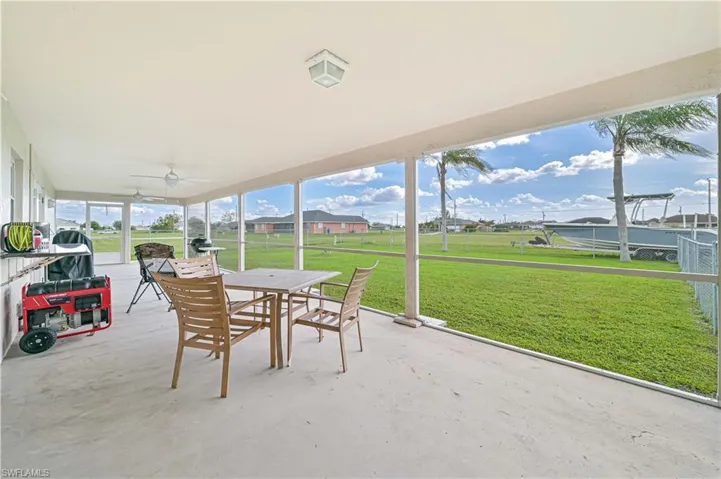 Sunroom / solarium with outdoor dining area and a ceiling fan