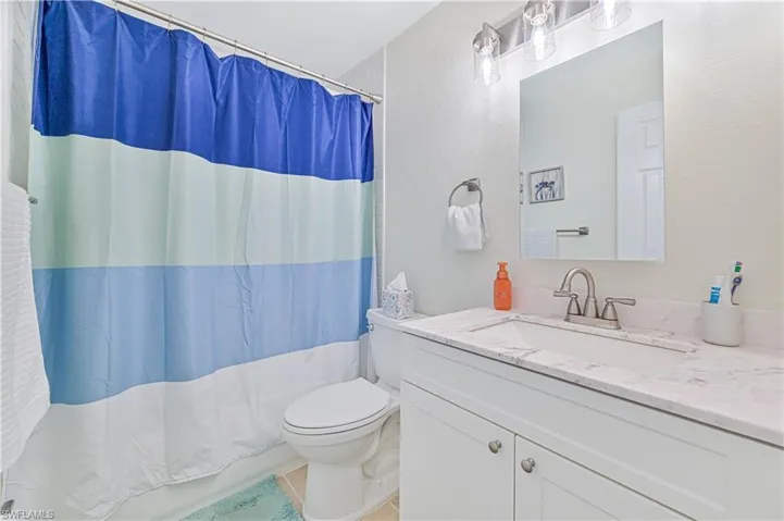 Full bathroom featuring vanity and tile patterned flooring