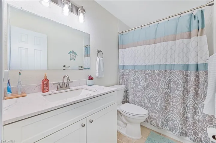 Bathroom with tile patterned flooring and vanity