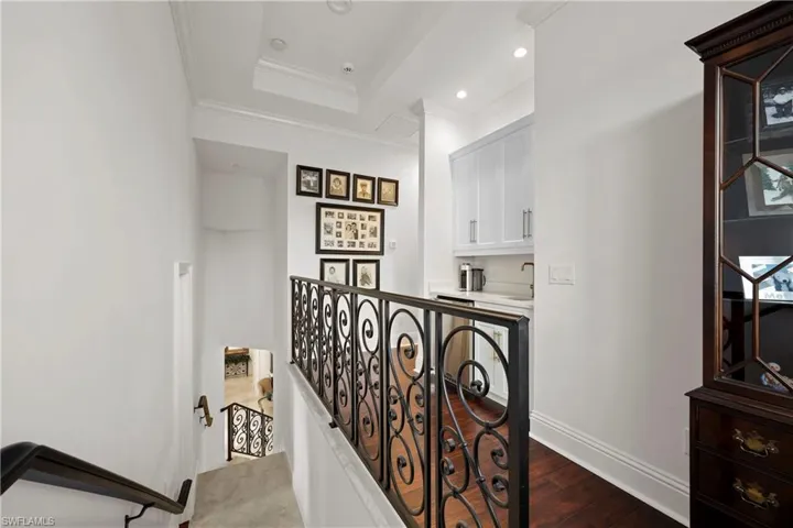 Landing to third floor with breakfast bar area, sink and refrigerator