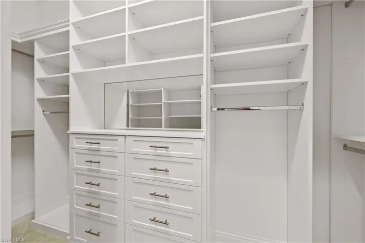 Owners suite features two walk in closets with new custom fixtures